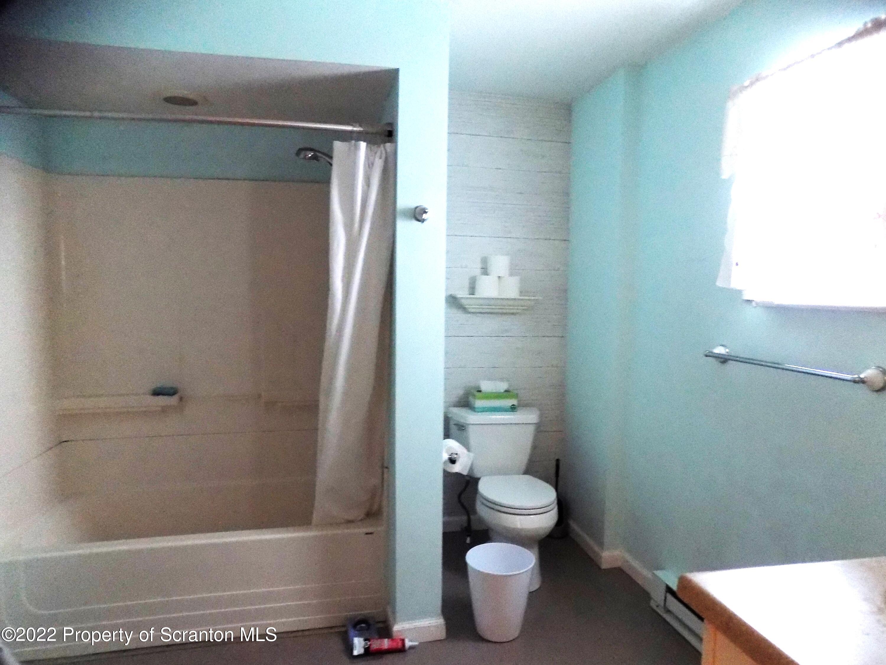 624 Court Street Scranton, PA 18508 - Photo 6 of 13 a bathroom with a toilet and a shower