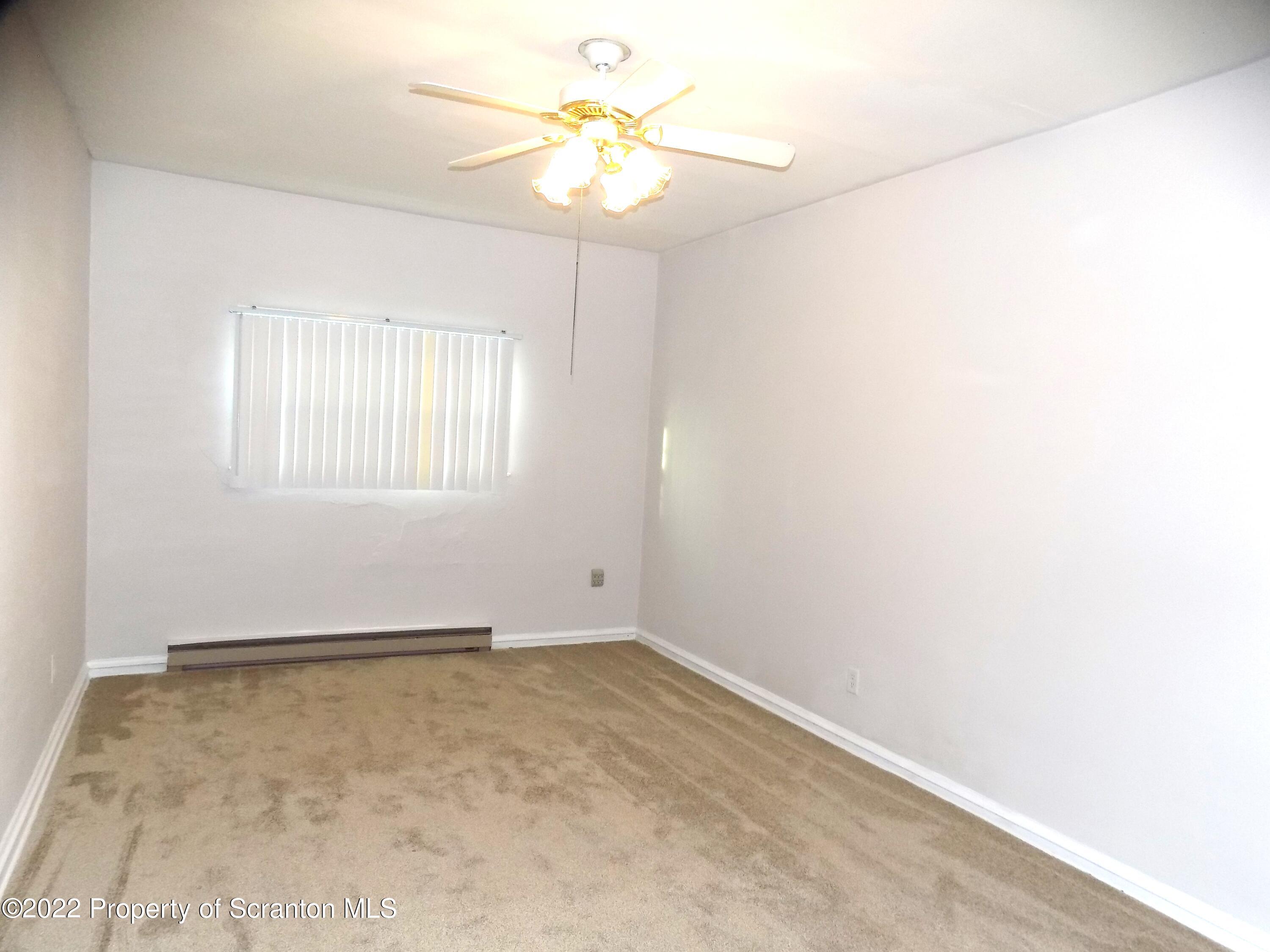 624 Court Street Scranton, PA 18508 - Photo 7 of 13 an empty room with windows and fan