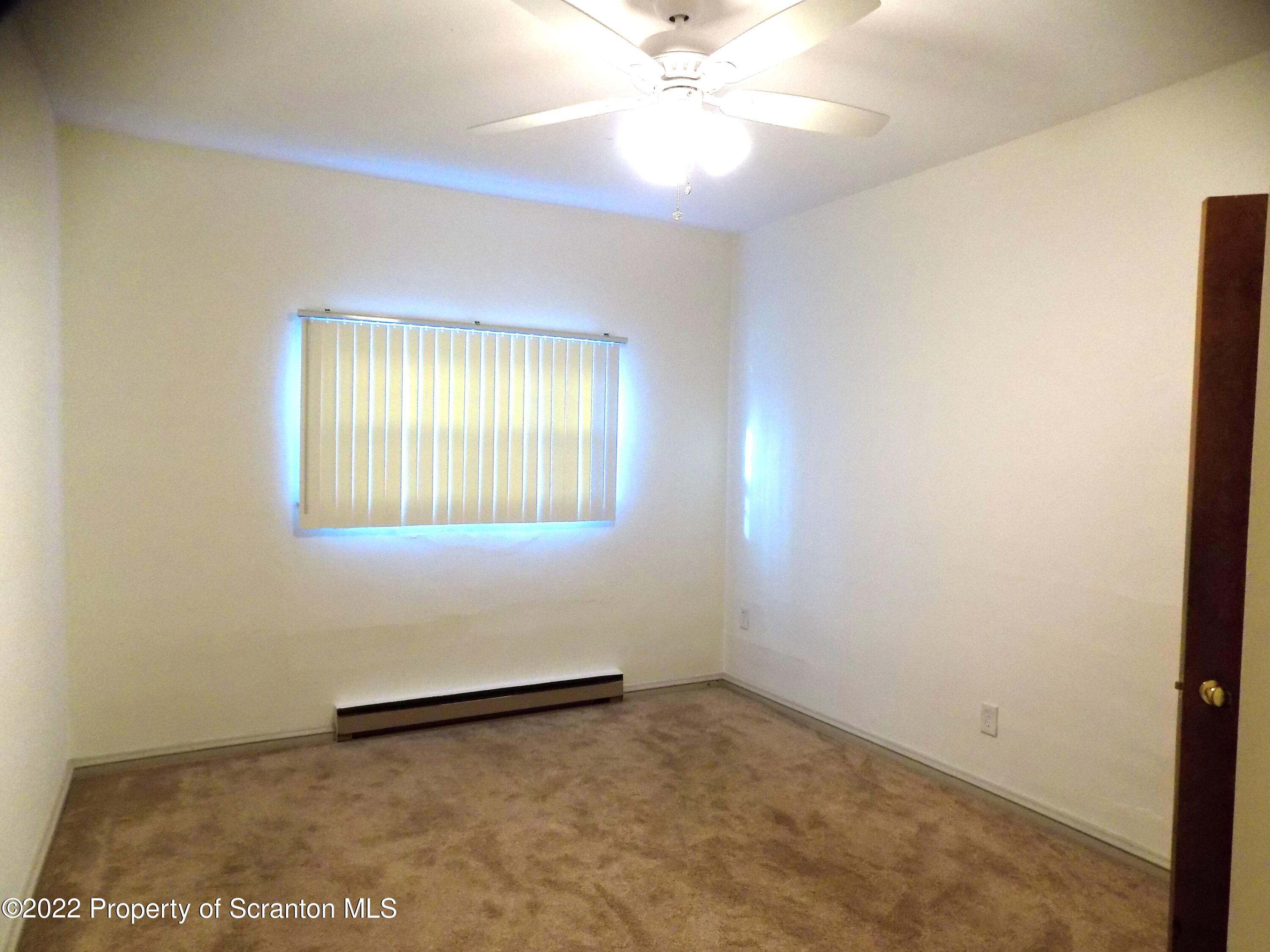 624 Court Street Scranton, PA 18508 - Photo 8 of 13 an empty room with windows and fan