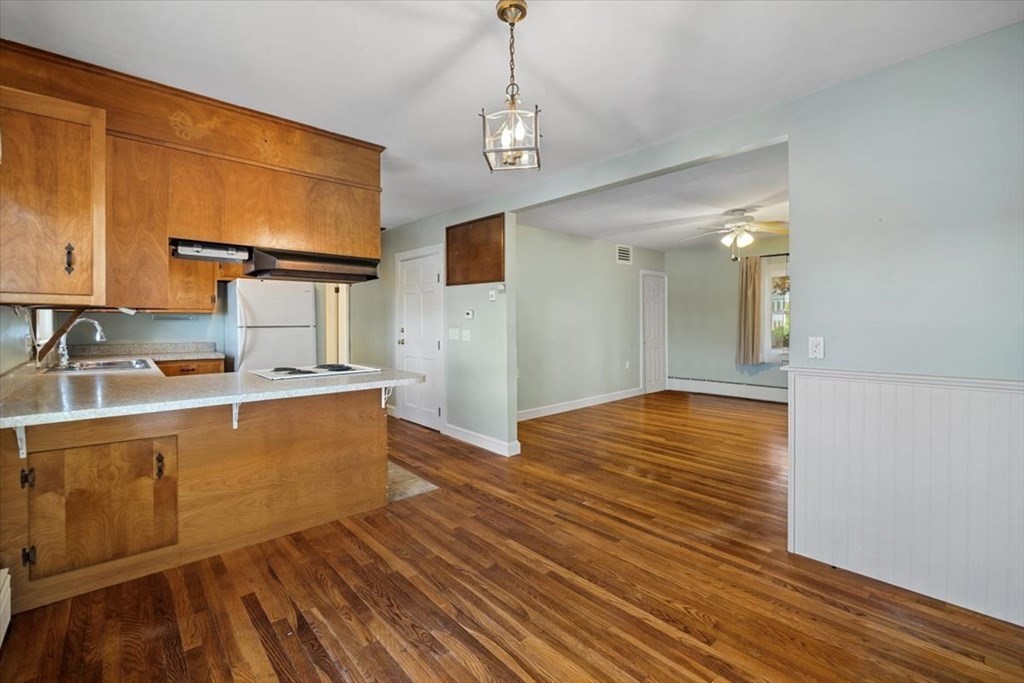 12 Nye Lane Bourne, MA 02532 - Photo 19 of 38 a view of a kitchen with wooden floor and a sink