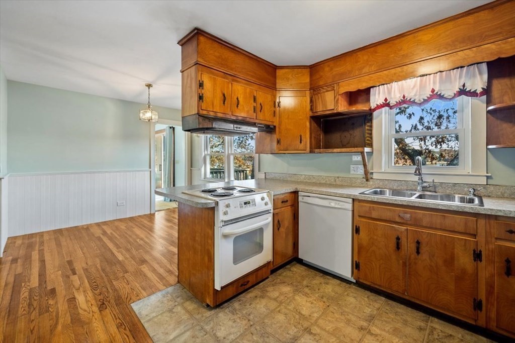 12 Nye Lane Bourne, MA 02532 - Photo 24 of 38 a kitchen with stainless steel appliances granite countertop a sink cabinets and wooden floor