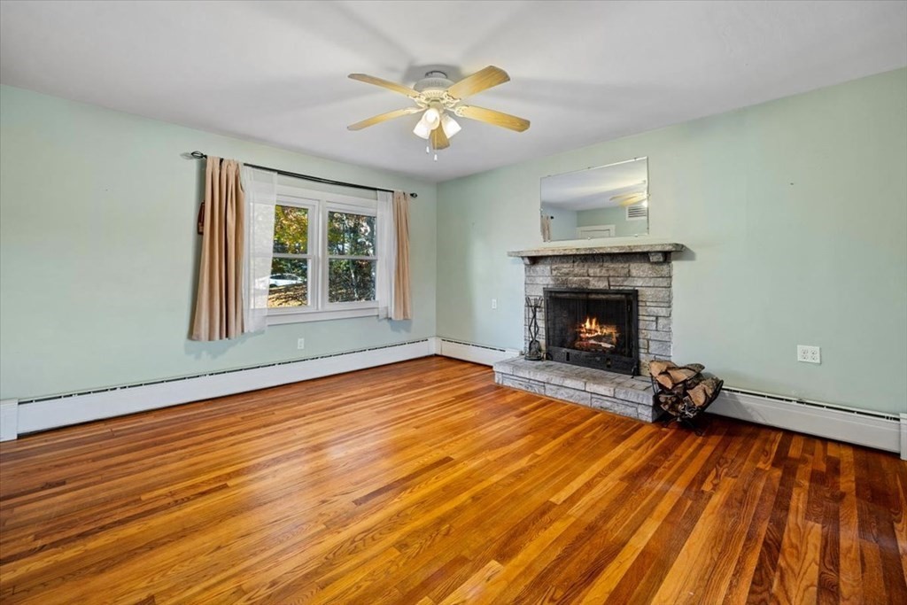12 Nye Lane Bourne, MA 02532 - Photo 25 of 38 a view of an empty room with wooden floor fireplace and a window