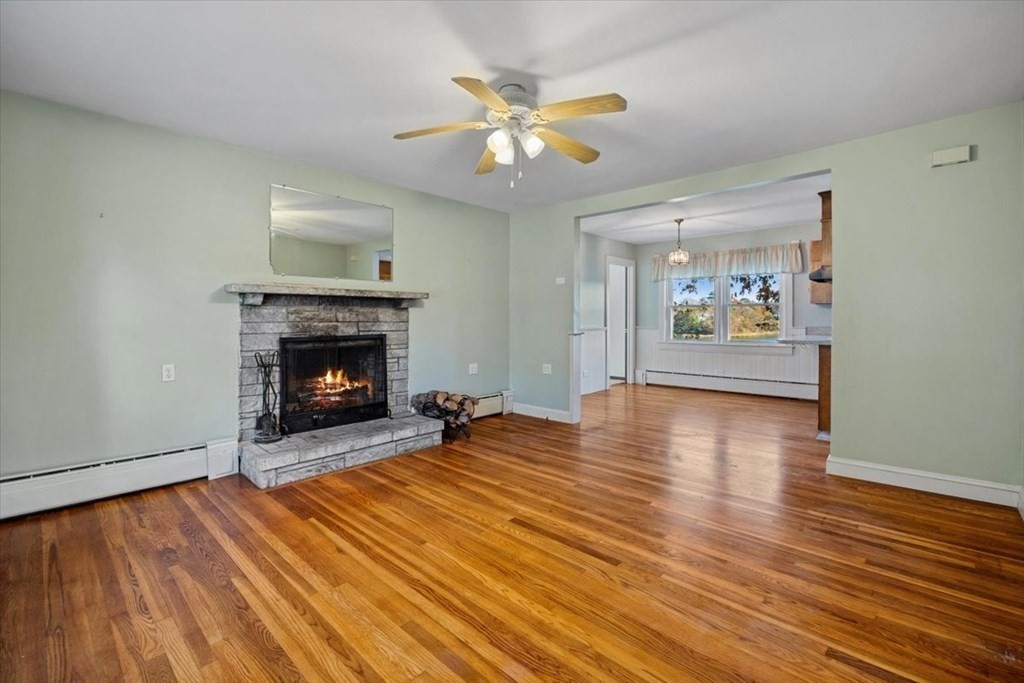 12 Nye Lane Bourne, MA 02532 - Photo 26 of 38 a view of empty room with wooden floor and fireplace