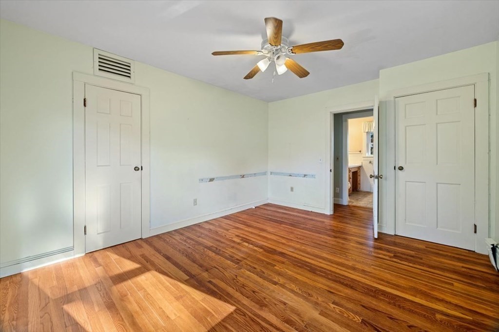 12 Nye Lane Bourne, MA 02532 - Photo 31 of 38 a bedroom with a bed and a chandelier