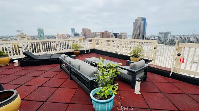 a view of a terrace with chairs and a potted plant
