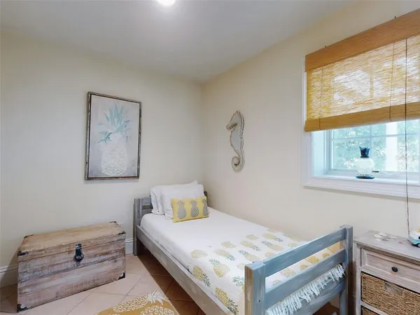 a bedroom with a bed and window