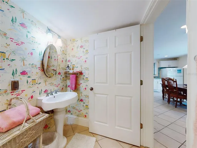a bathroom with a sink mirror and a shower curtain
