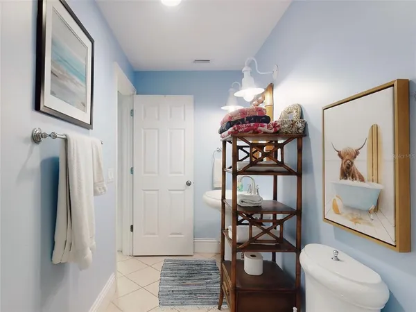 a view of a hallway with furniture and a floor to ceiling window