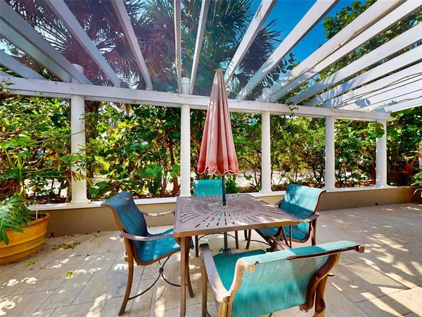 a view of a patio with a dining table and chairs