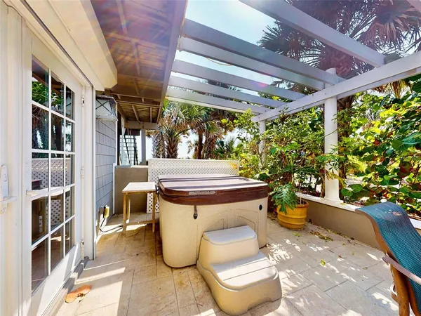 a view of a patio with table and chairs and potted plants