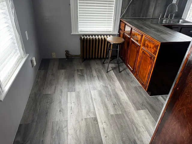 a view of a room with wooden floor and windows
