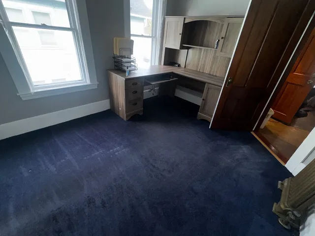 a room with window and a flat screen tv