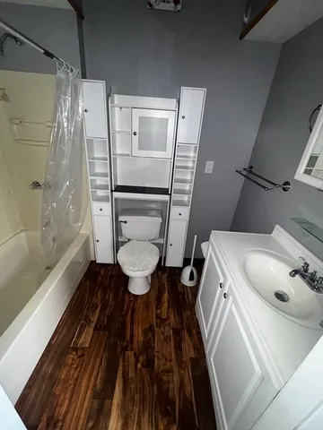 a bathroom with a toilet and a shower