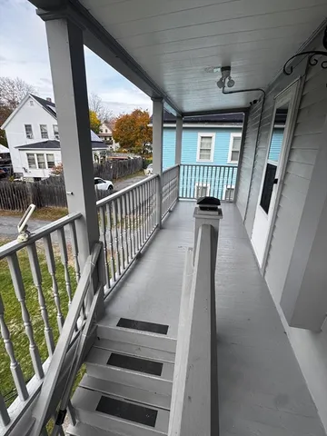 a view of staircase with wooden floor and a window