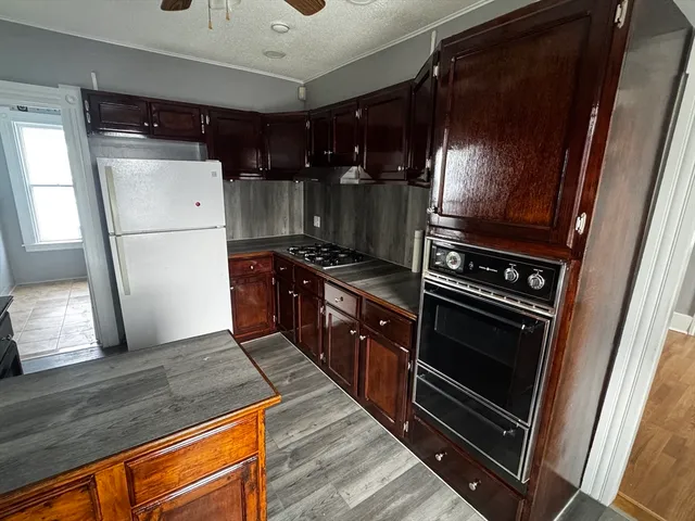 a kitchen with wooden cabinets and stainless steel appliances