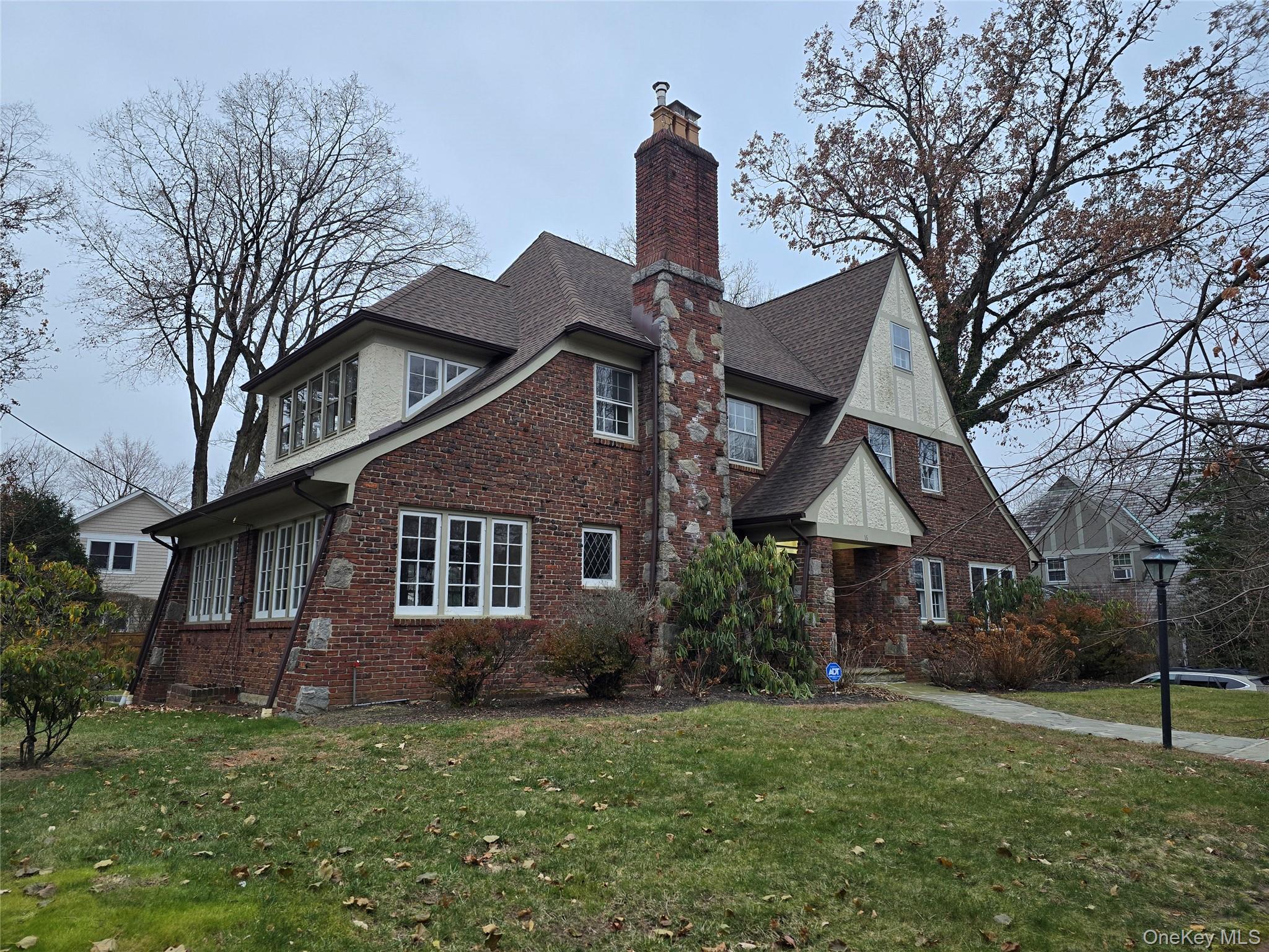 16 Bon Air Avenue New Rochelle, NY 10804 - Photo 2 of 25 a front view of a house with a garden