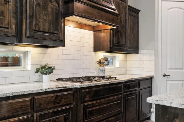 a kitchen with granite countertop stainless steel appliances and cabinets