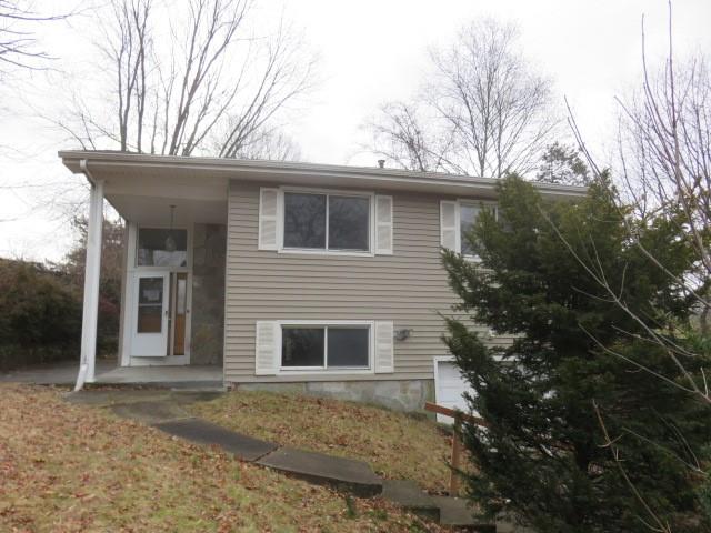a view of a house with a yard and garage