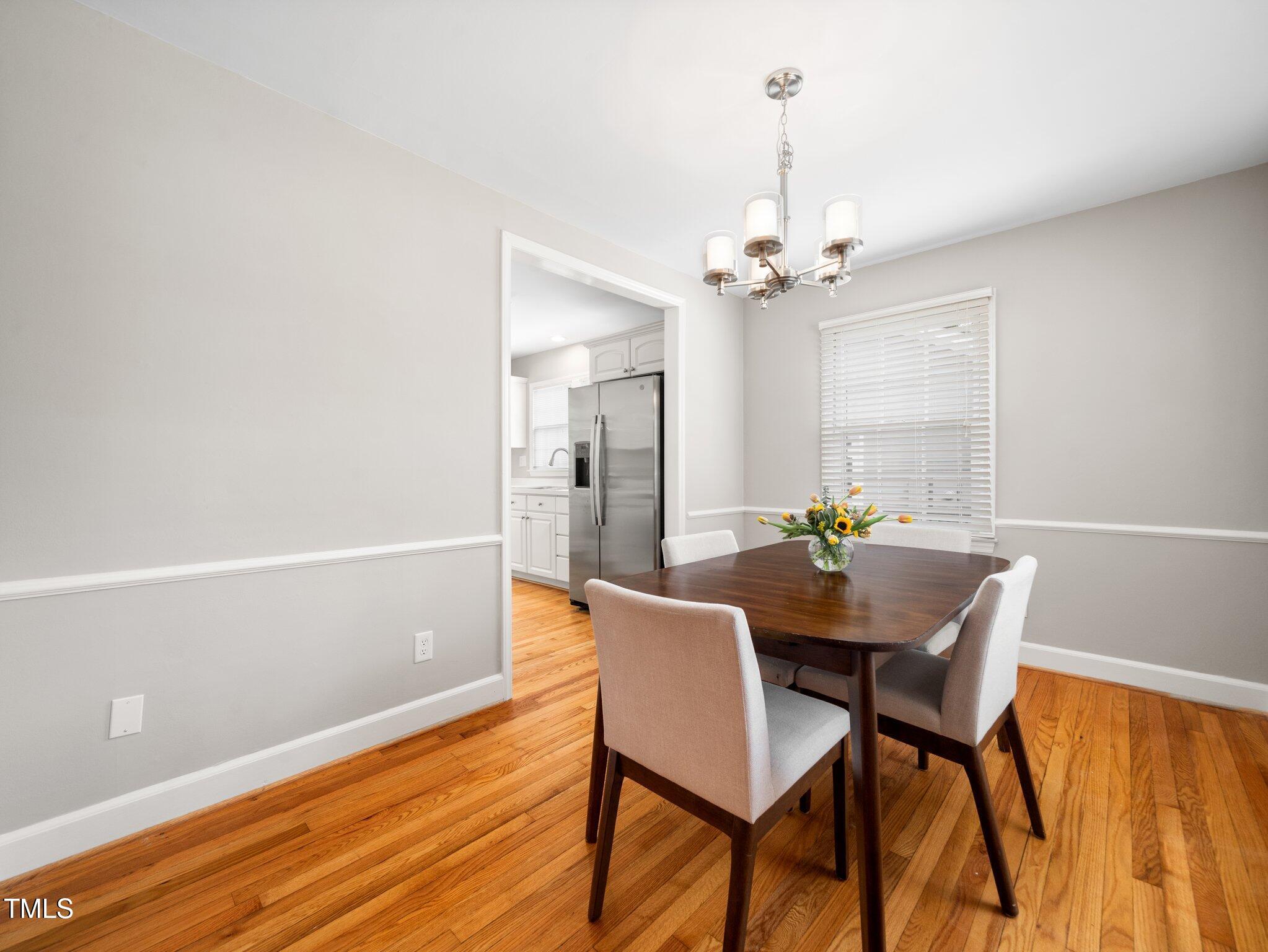 1313 Ridge Road Raleigh, NC 27607 - Photo 11 of 37 a view of a dining room with furniture and a chandelier