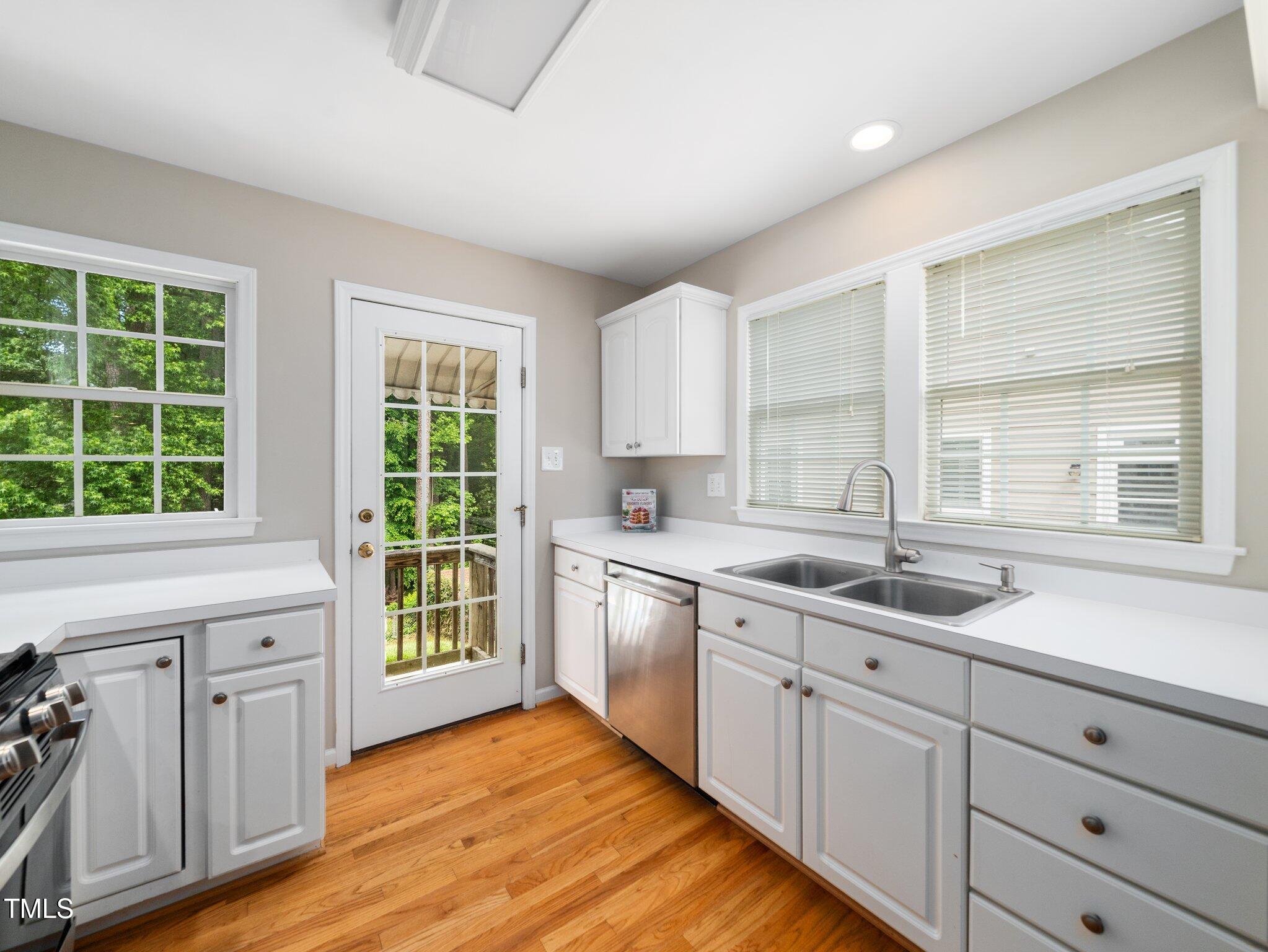 1313 Ridge Road Raleigh, NC 27607 - Photo 15 of 37 a kitchen with sink window and cabinets