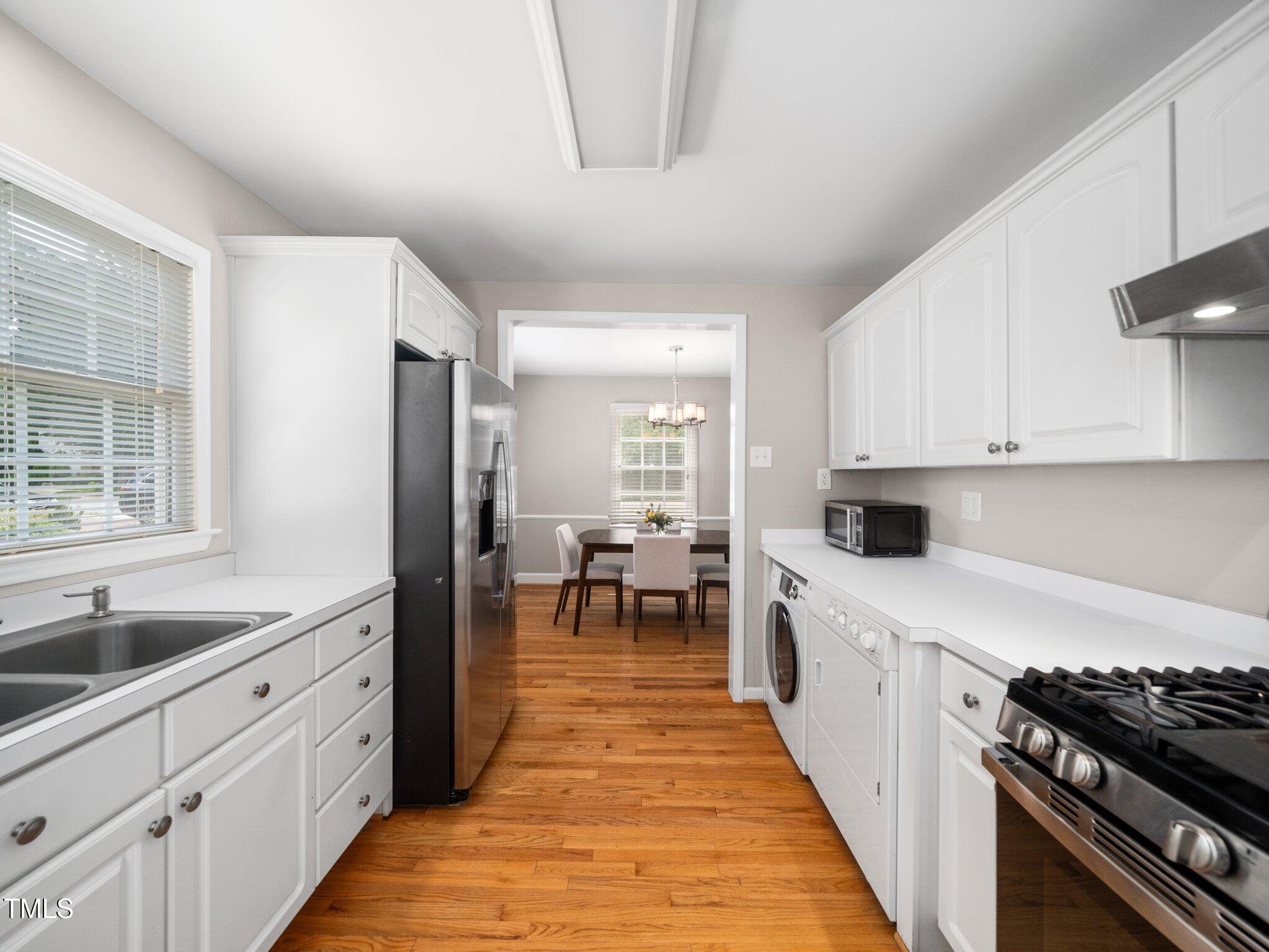 1313 Ridge Road Raleigh, NC 27607 - Photo 17 of 37 a kitchen with white cabinets and appliances
