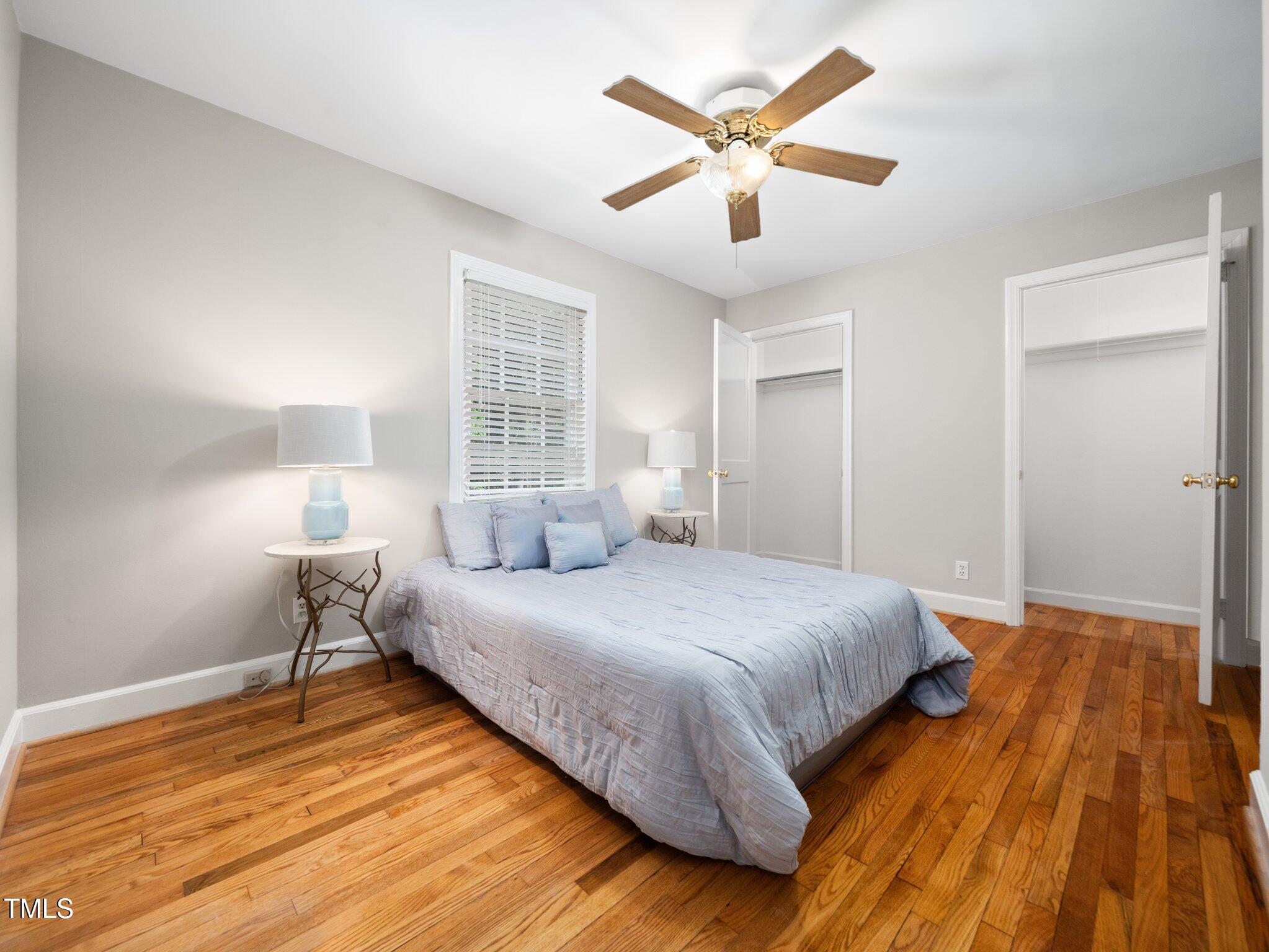 1313 Ridge Road Raleigh, NC 27607 - Photo 19 of 37 a bedroom with a bed and a chandelier