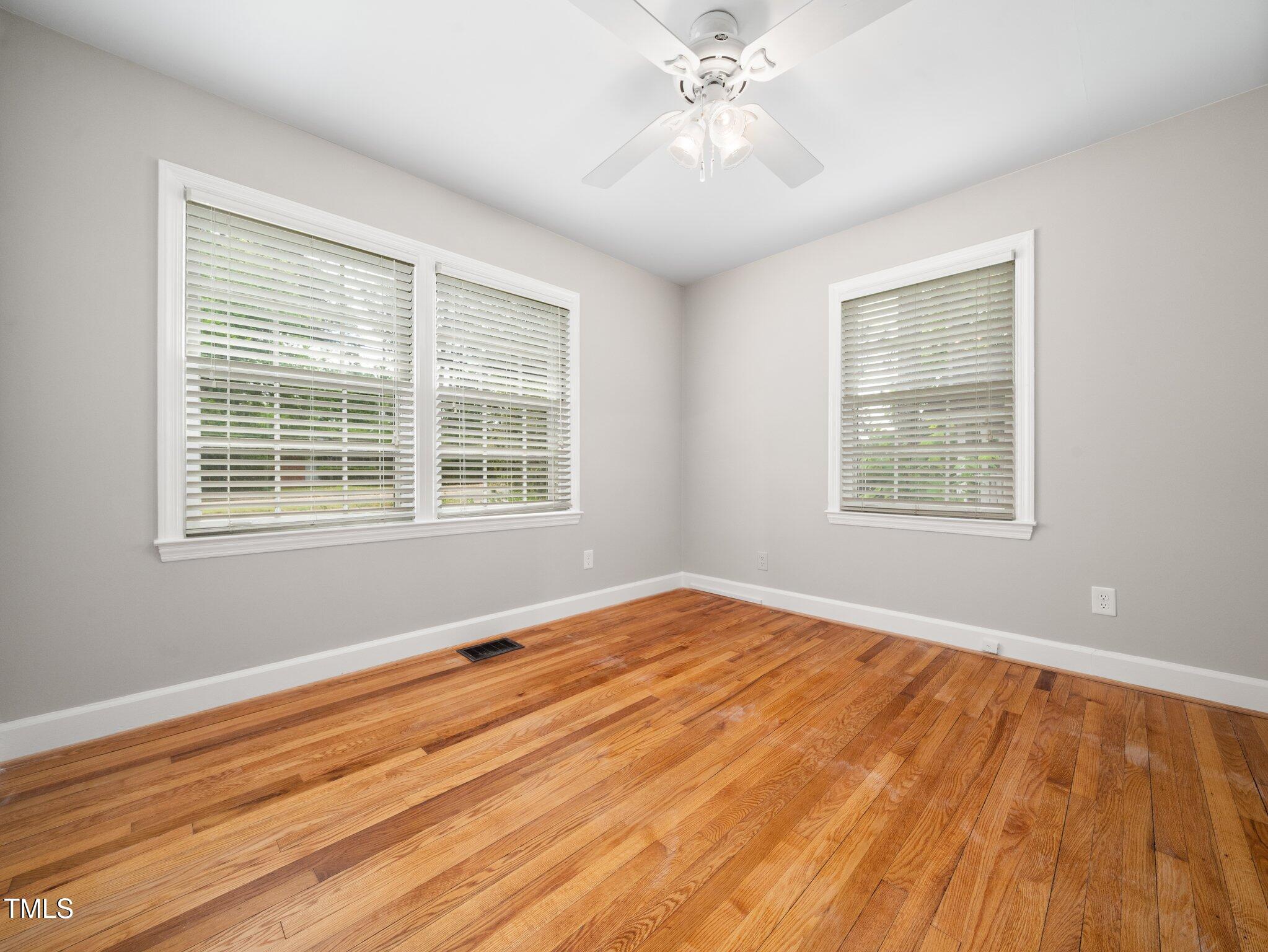 1313 Ridge Road Raleigh, NC 27607 - Photo 24 of 37 a view of an empty room with wooden floor and a window