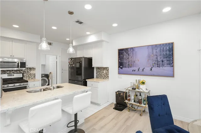 a living room with furniture and kitchen view