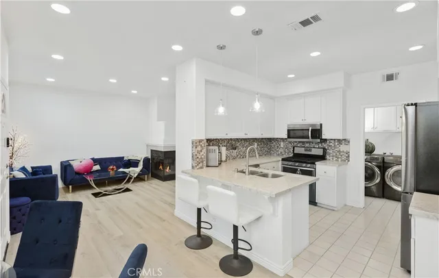 a kitchen with stainless steel appliances kitchen island granite countertop a sink and cabinets