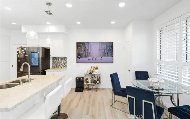 a large white kitchen with a large window