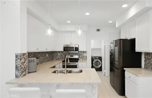 a kitchen with refrigerator and stove