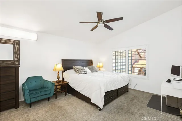 a bedroom with a bed a fireplace and a window