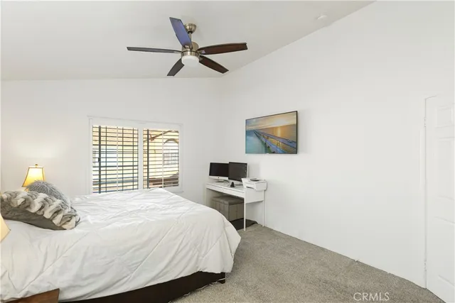 a bedroom with a bed and a desk