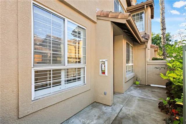 a front view of a house with a plants