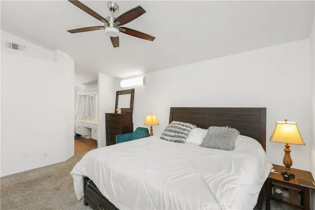 a bedroom with a bed and a lamp