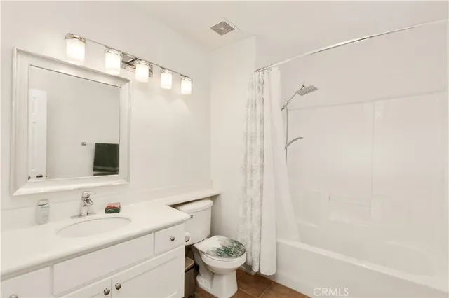 a bathroom with a sink toilet mirror and shower
