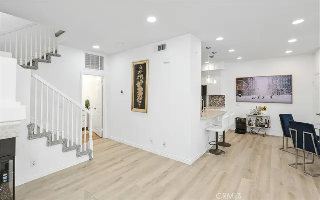 a view of a livingroom with wooden floor and furniture