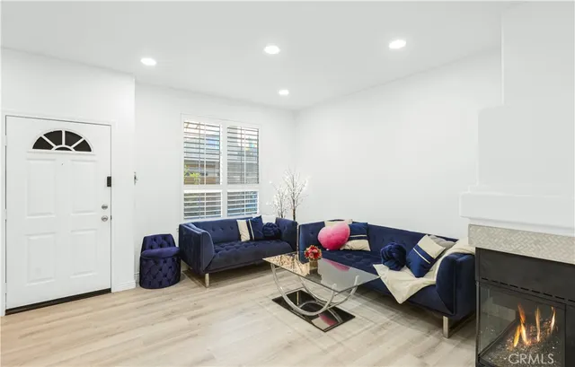 a living room with furniture window and wooden floor