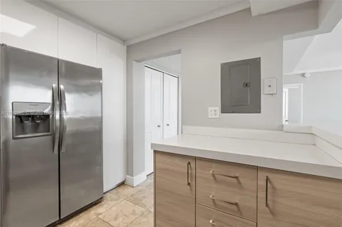 a kitchen with a refrigerator and cabinet