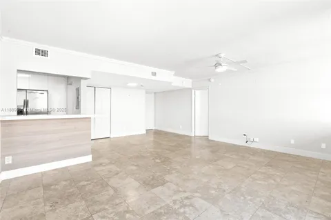 a view of an empty room with a kitchen