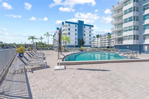 a view of water with boats and trees in the background