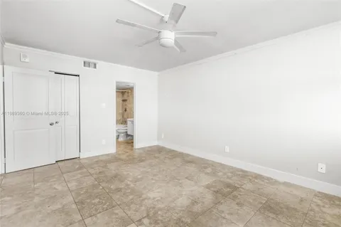an empty room with fan and a ceiling fan