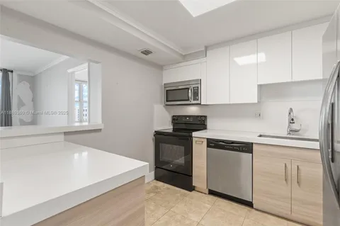 a kitchen with a sink stove and microwave
