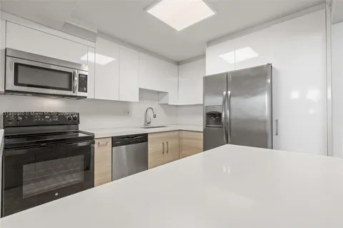 a kitchen with stainless steel appliances granite countertop a refrigerator stove and sink