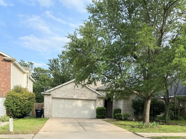 2224 Kerr Trail Cedar Park, TX 78613 - Photo 2 of 15 a front view of a house with a garden
