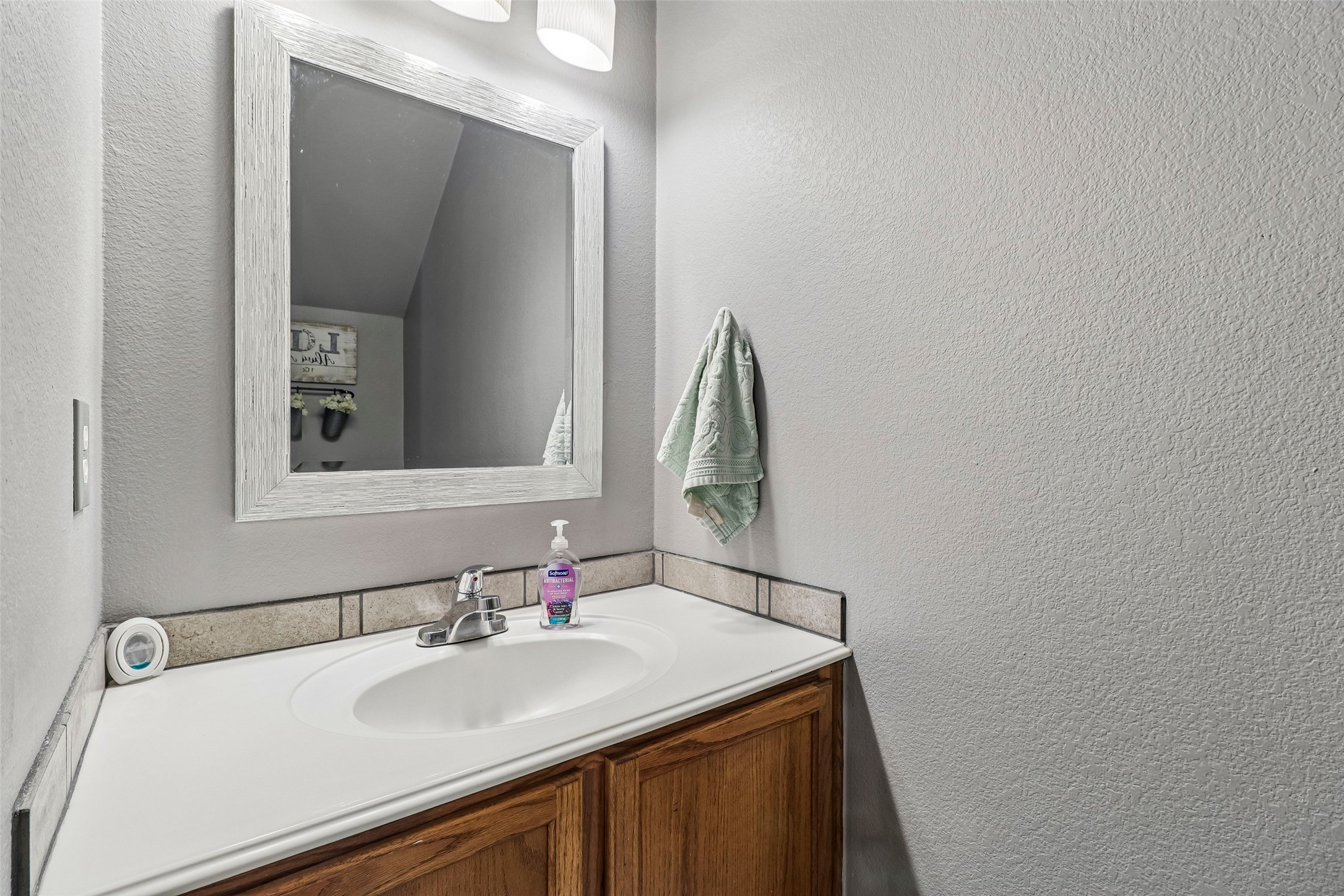 311 A Utterback Kyle, TX 78640 - Photo 27 of 40 a bathroom with a sink and a mirror