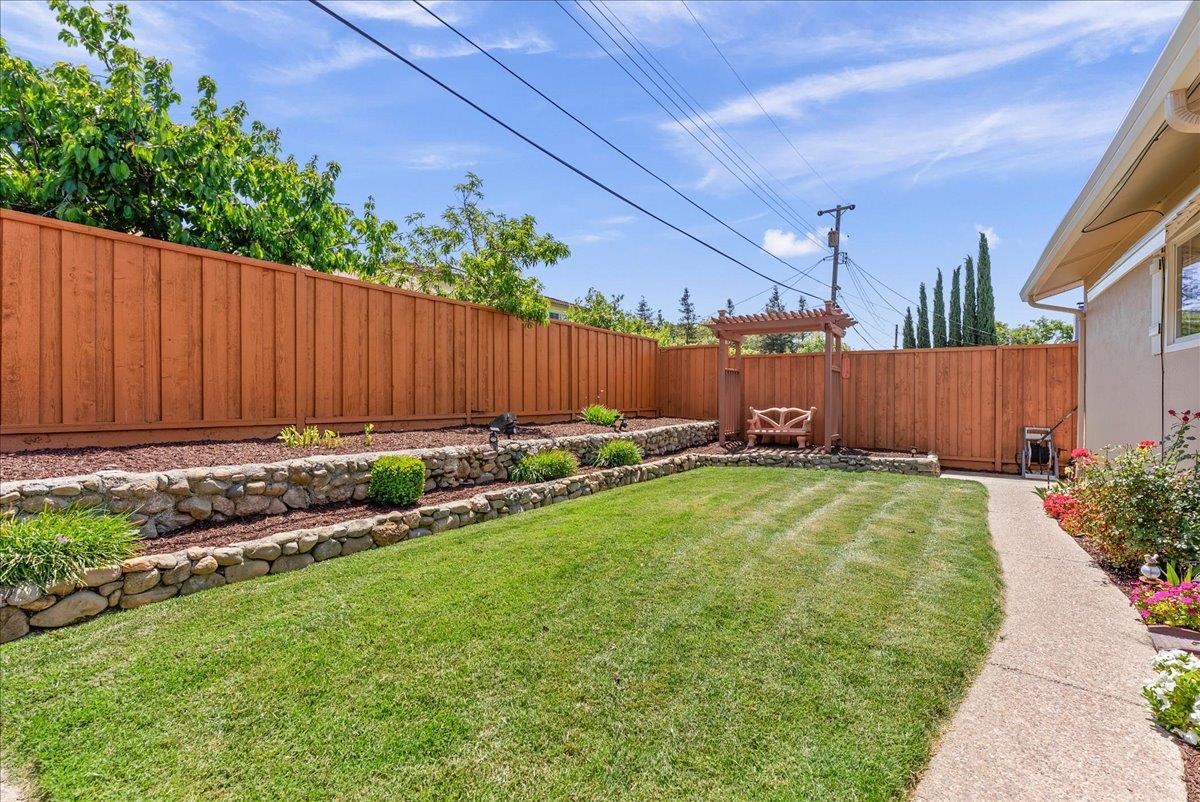 1648 Mt Rainier Avenue Milpitas, CA 95035 - Photo 31 of 34 a view of a backyard with potted plants and wooden fence