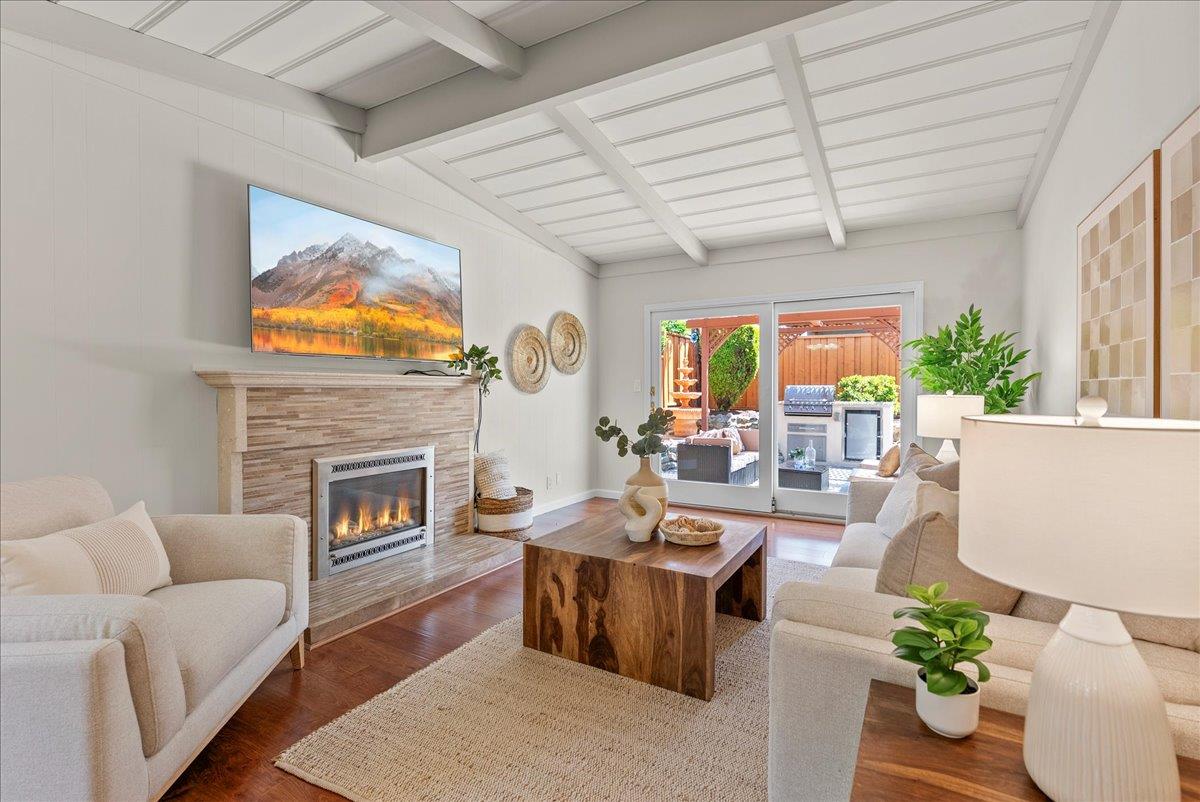 1648 Mt Rainier Avenue Milpitas, CA 95035 - Photo 9 of 34 a living room with furniture a fireplace and a flat screen tv
