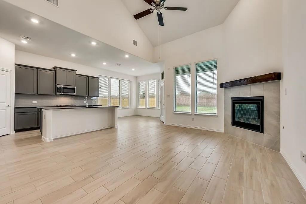3900 Falcon Field Mesquite, TX 75181 - Photo 2 of 12 a view of kitchen with kitchen island wooden floor and a fireplace