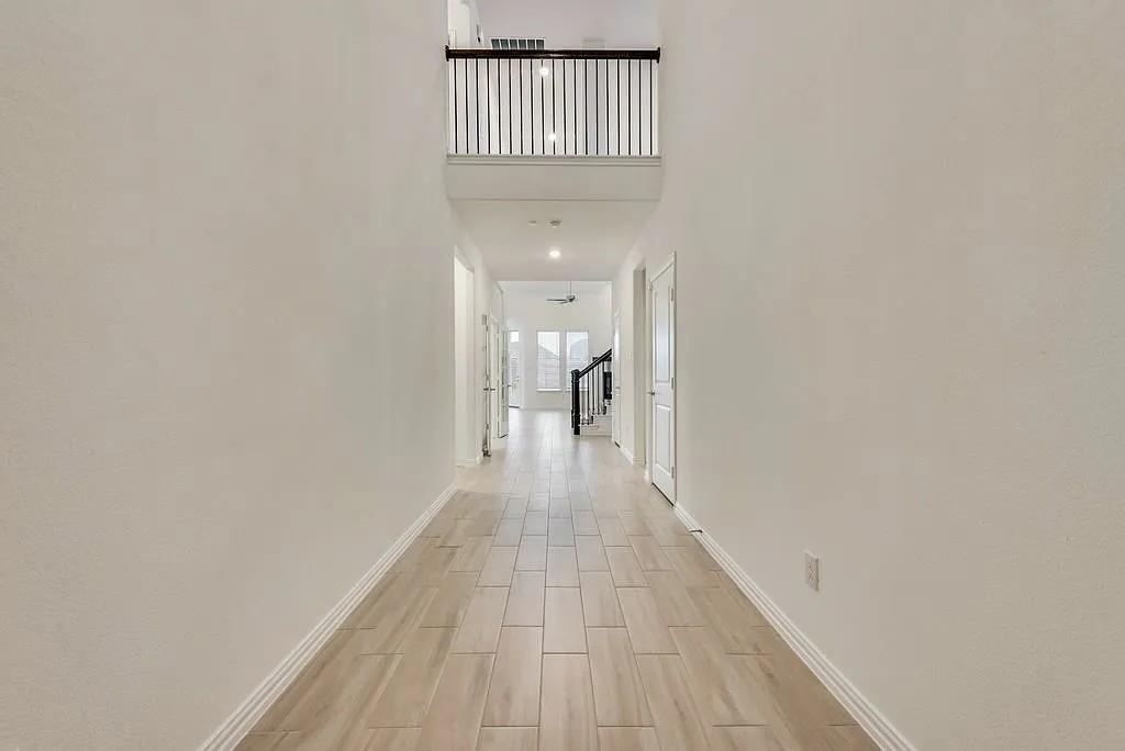 3900 Falcon Field Mesquite, TX 75181 - Photo 5 of 12 a view of a hallway with wooden floor and a bathroom